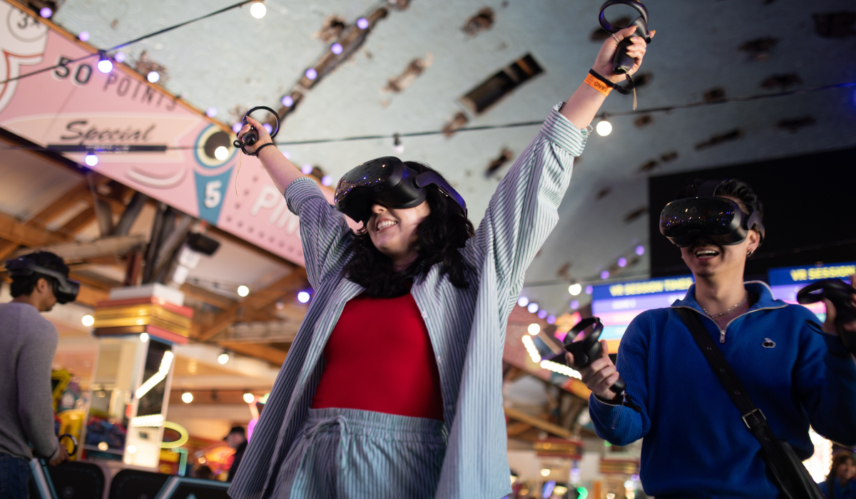 person wearing VR head set celebrating their VR win